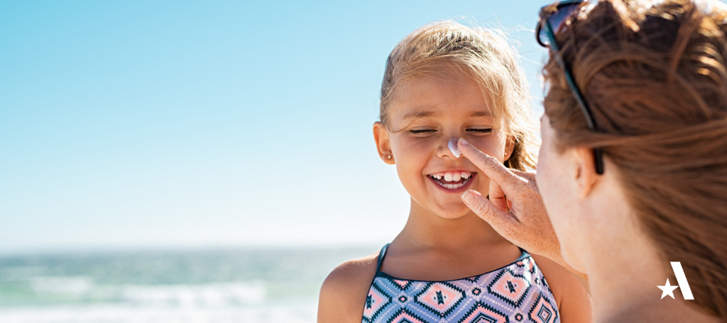 A Mom applies sunscreen to child's face